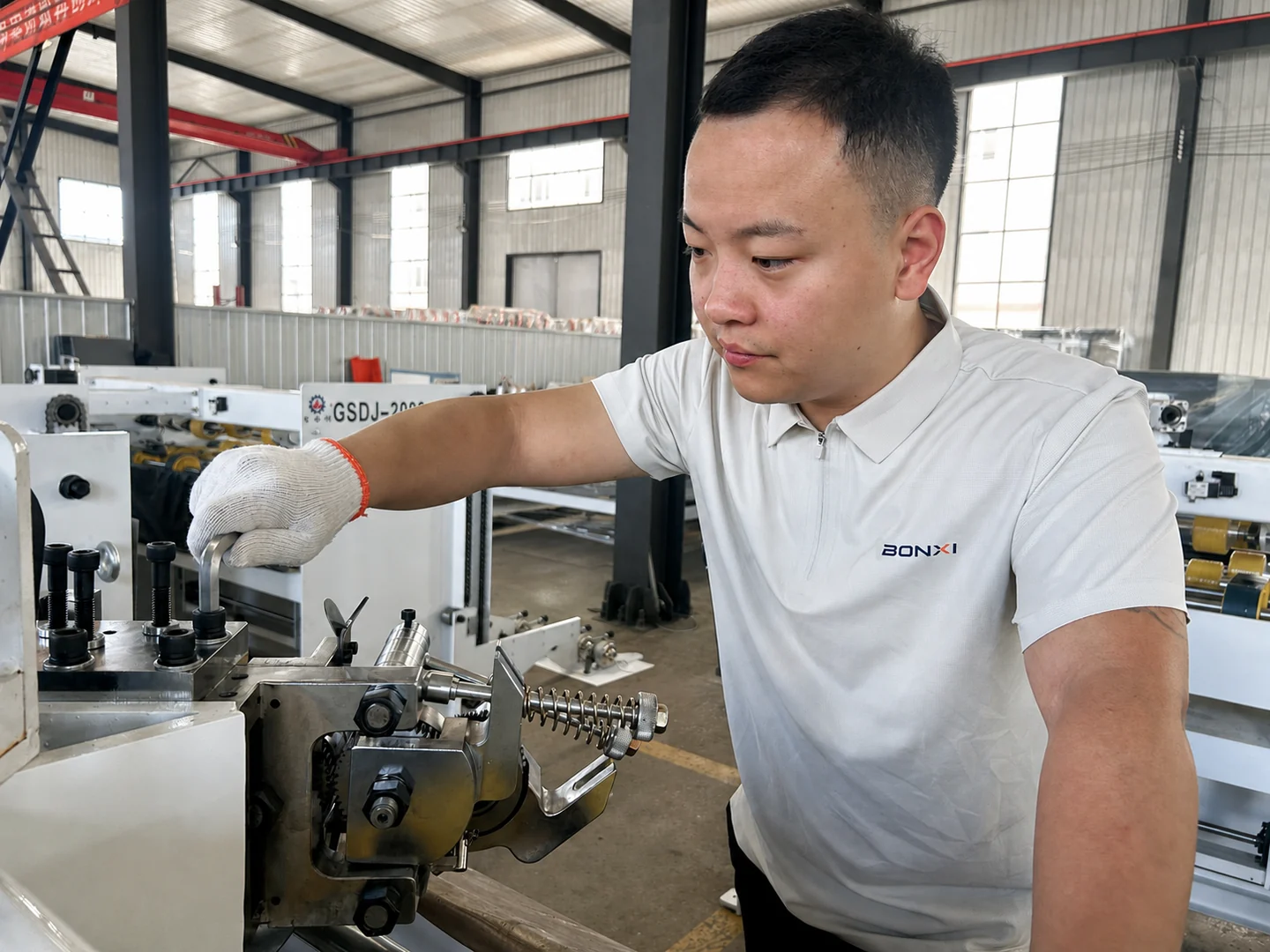 BONXI engineer inspecting carton packaging machinery in modern manufacturing factory