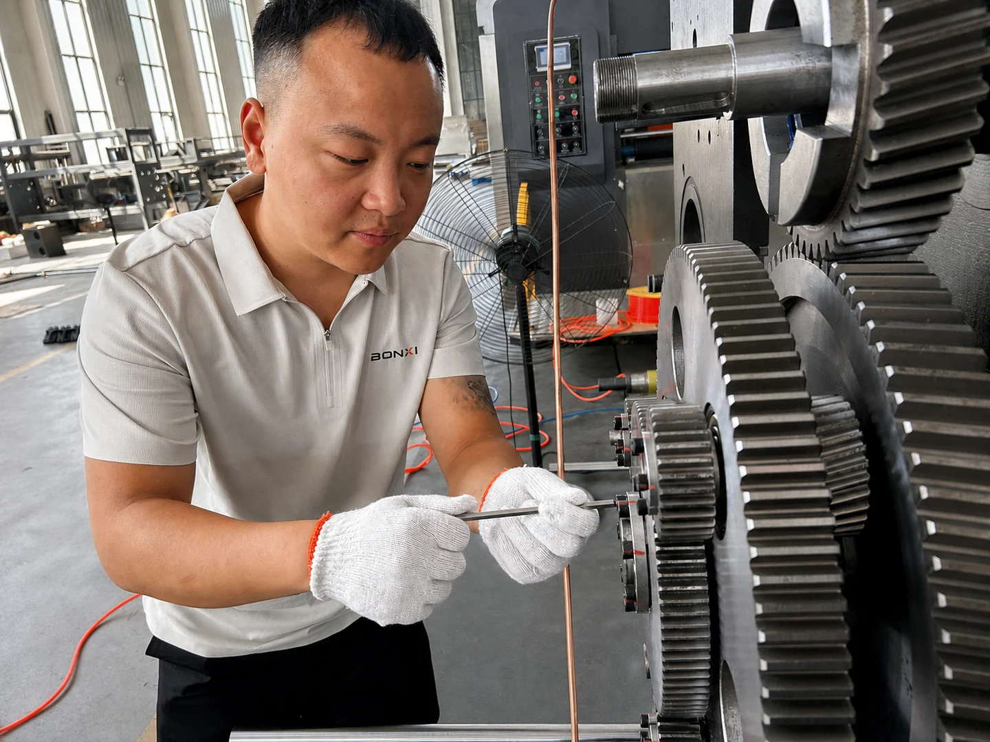 BONXI engineer inspecting carton packaging machinery in modern manufacturing factory